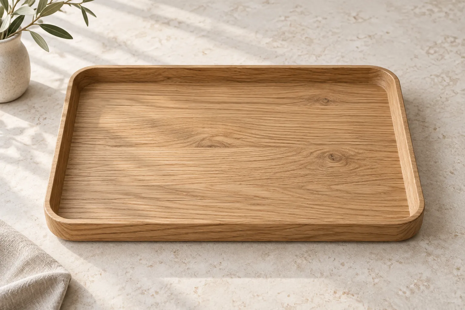 Rectangular oak tray with rounded corners on a pale stone surface.